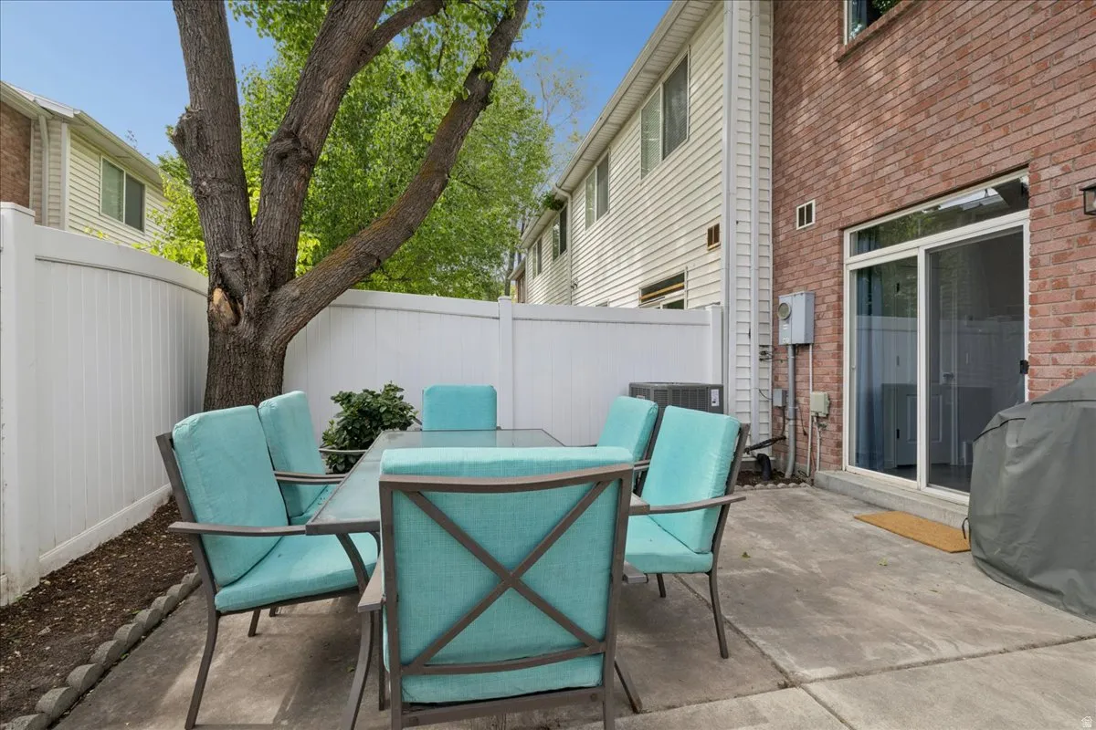 Fenced backyard featuring outdoor dining space, a patio area, and area for grilling