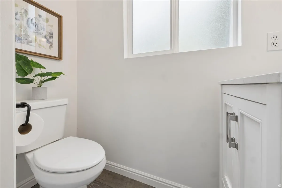Bathroom with wood finished floors and healthy amount of natural light