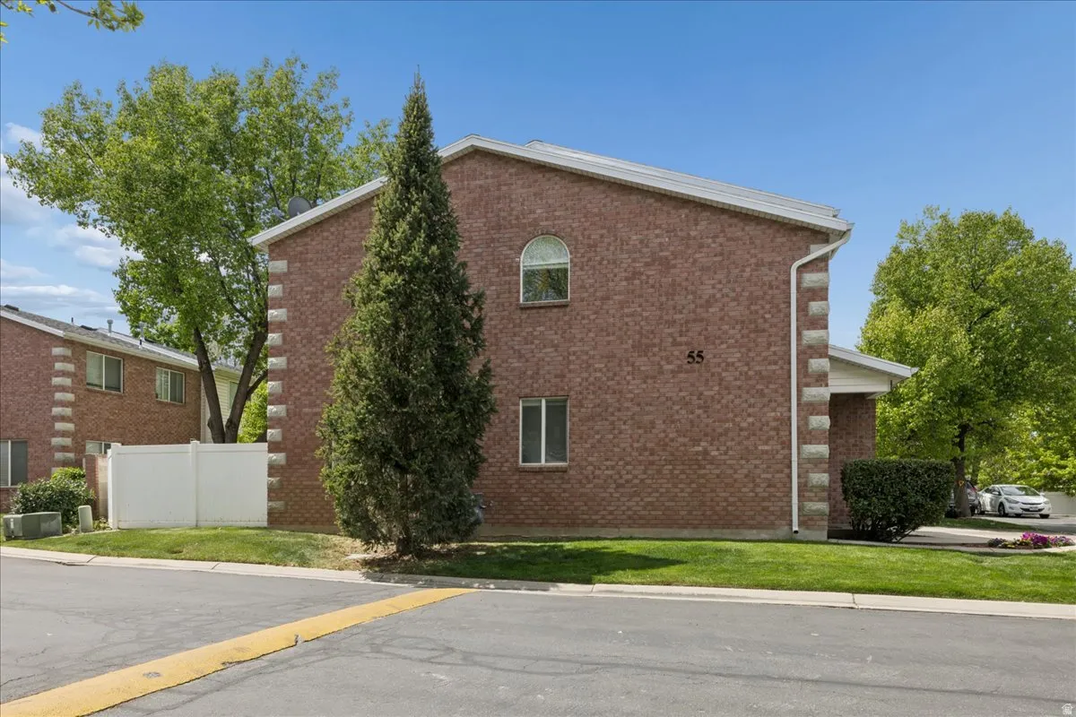 View of side of property featuring brick siding