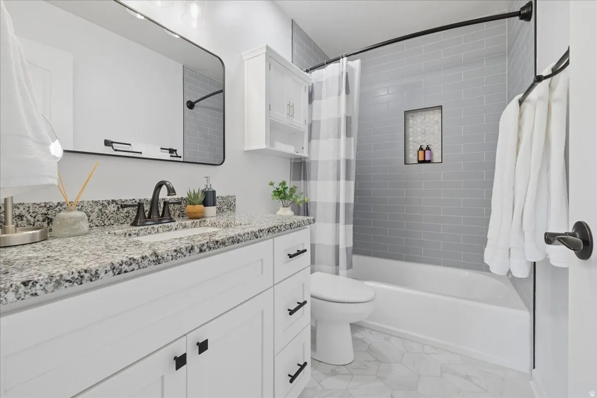Bathroom with vanity and shower / tub combo