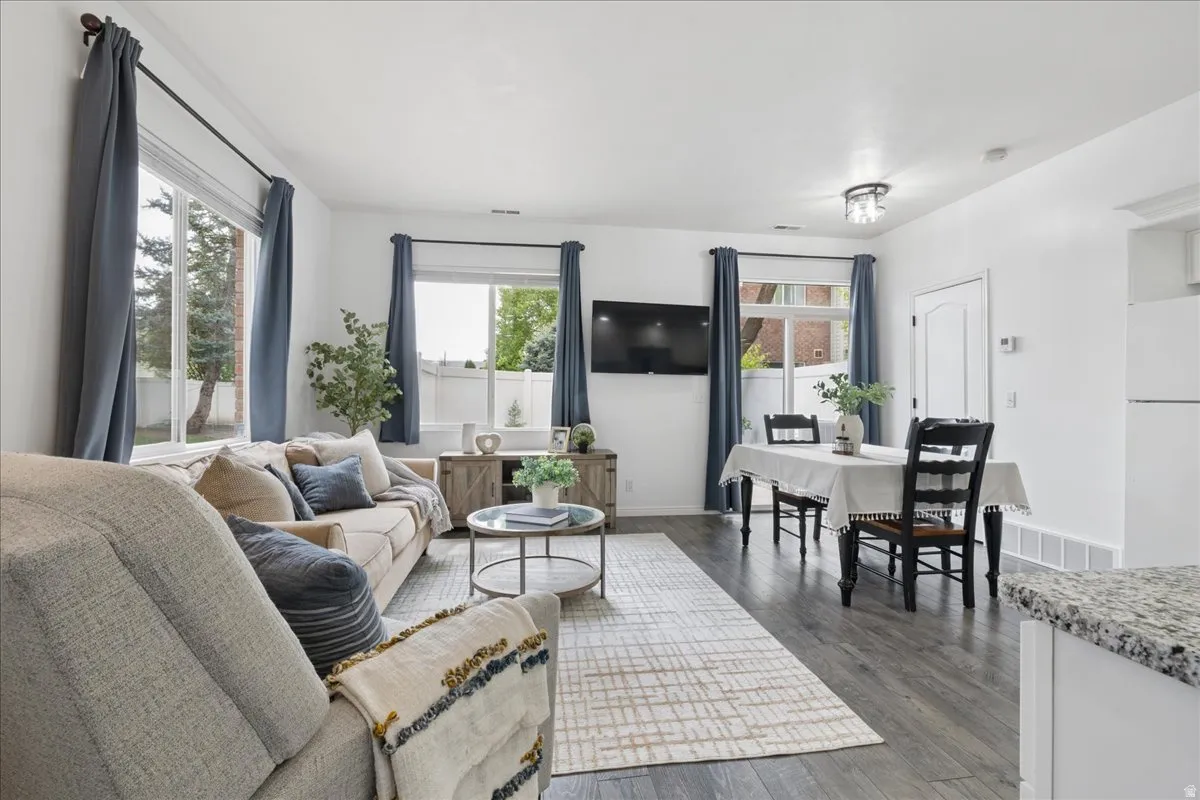 Living area with dark wood-style flooring and baseboards