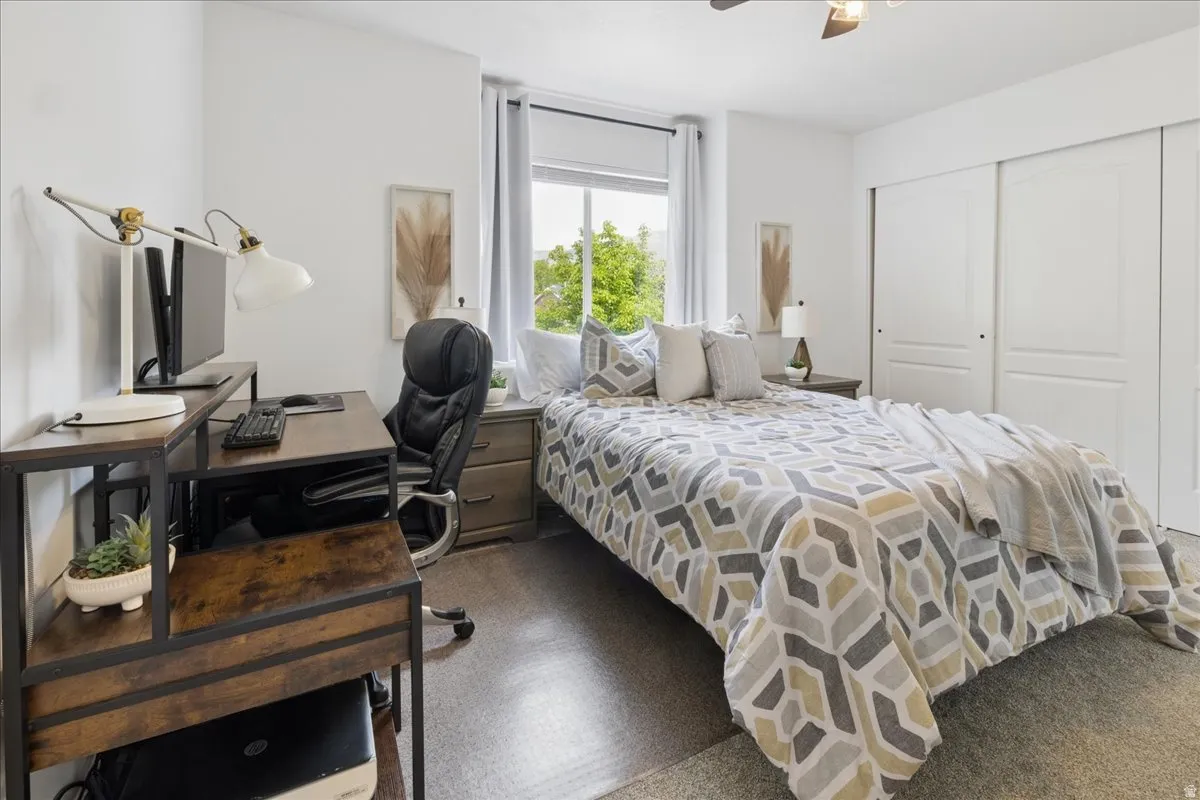Bedroom featuring an office area, a closet, and ceiling fan