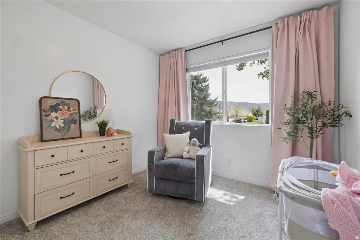 Sitting room with light colored carpet and baseboards