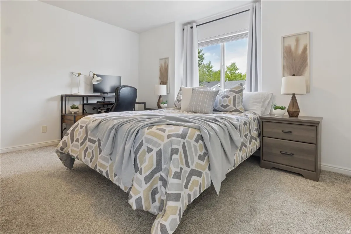 Bedroom featuring light carpet