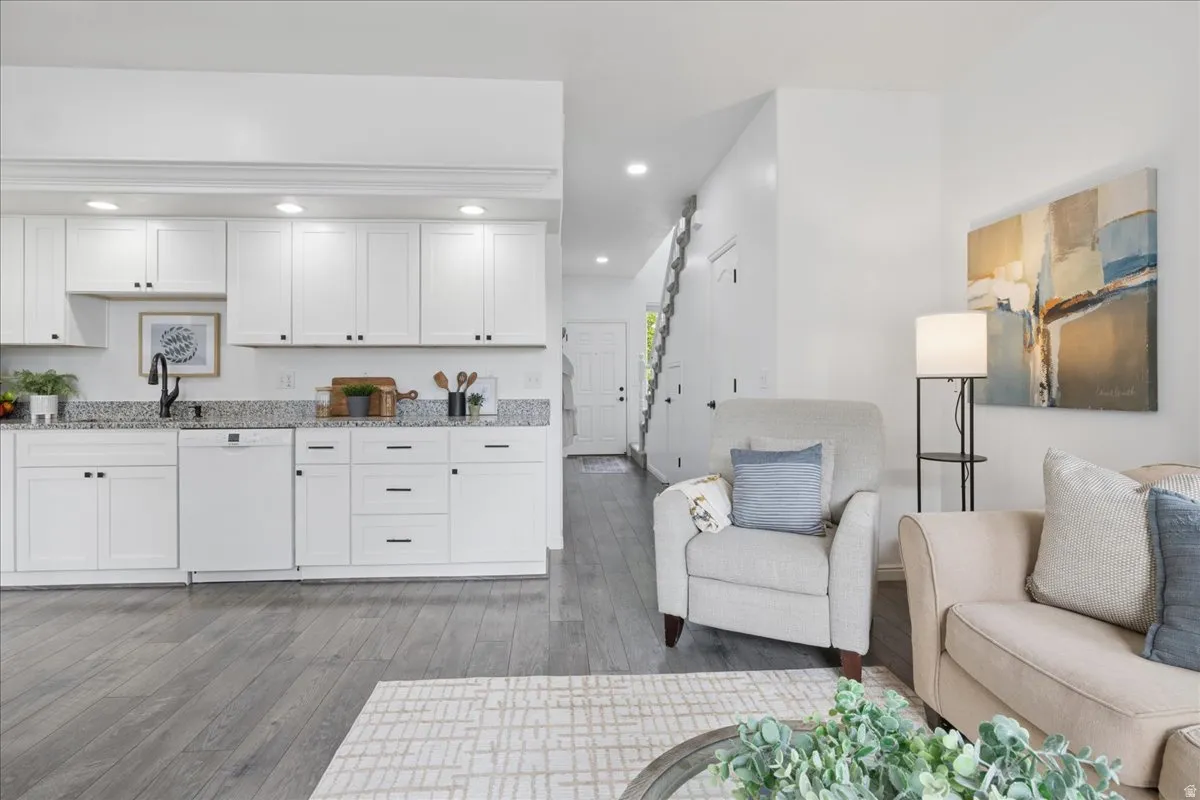 Living room featuring dark wood-style flooring and recessed lighting