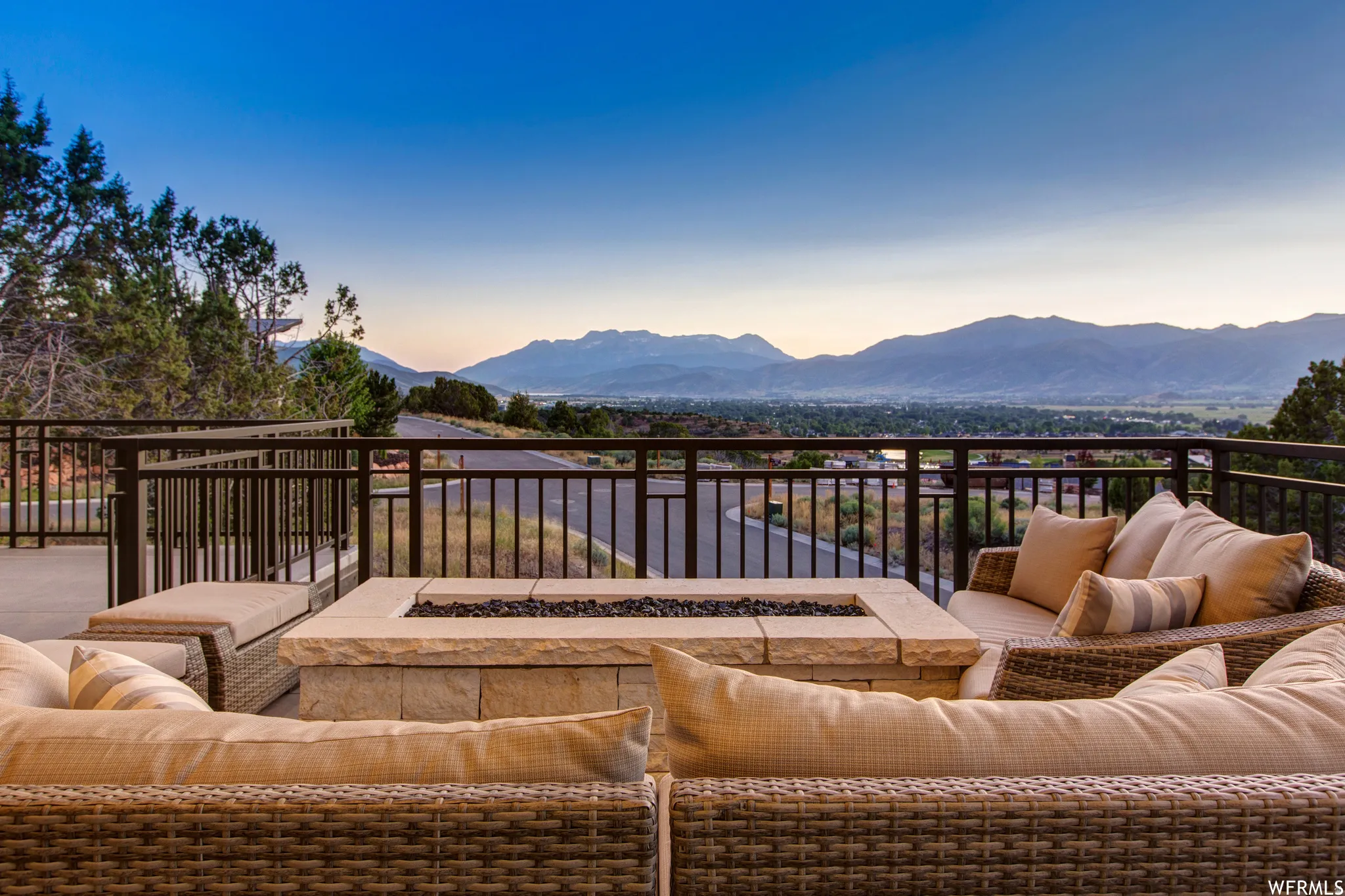 Balcony featuring an outdoor living space with a fire pit and a mountain view