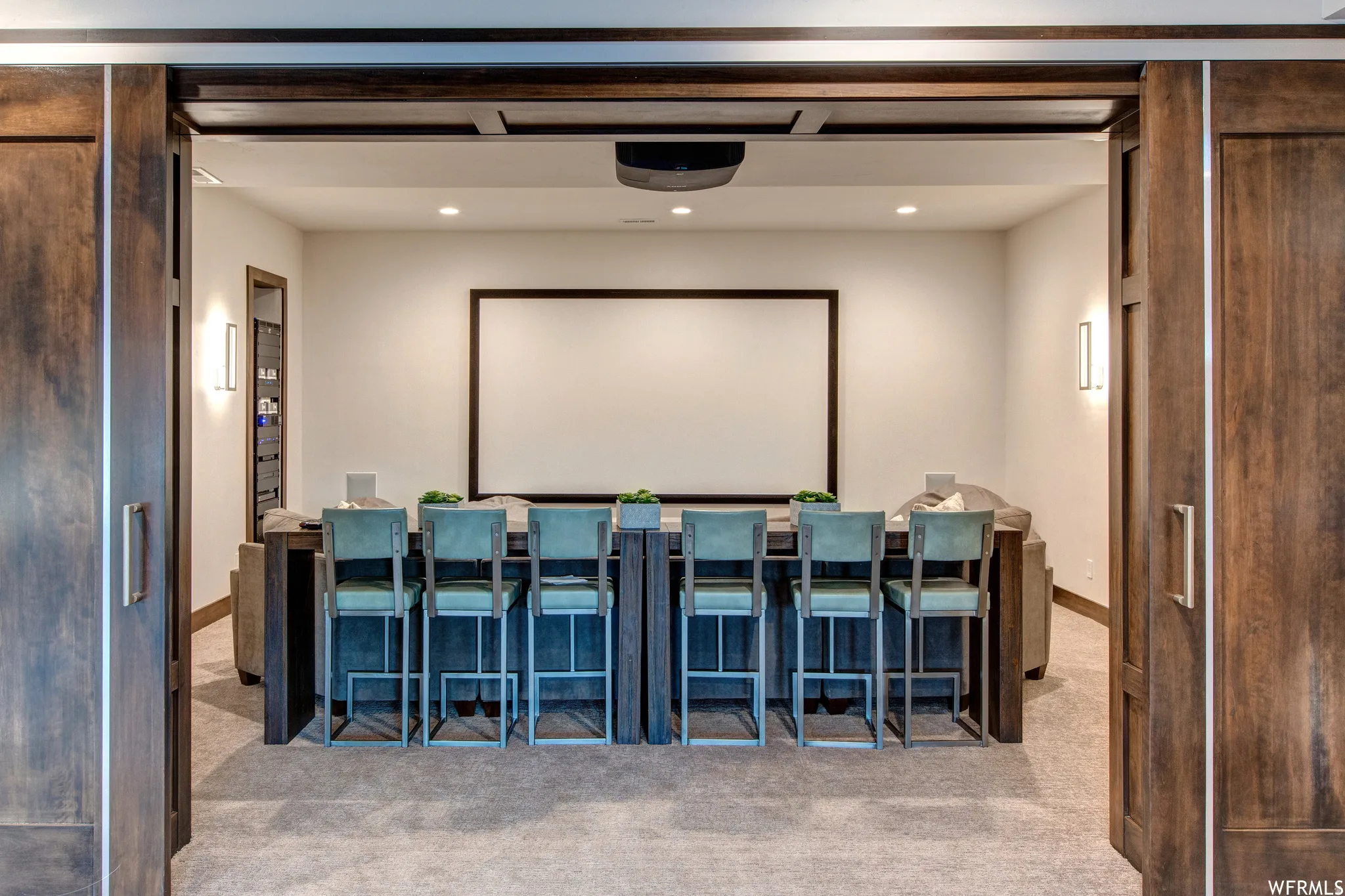 Home theater with recessed lighting and light carpet