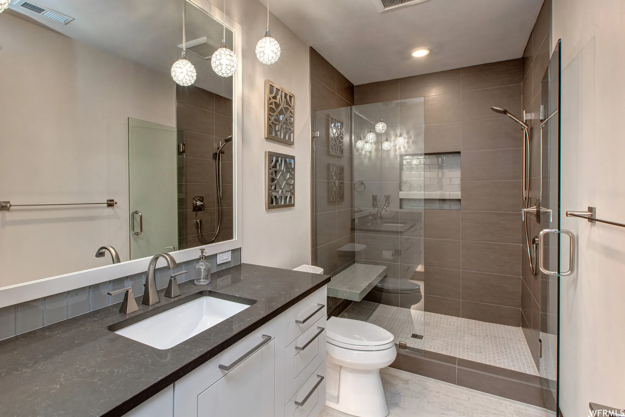 Full bath featuring vanity and a shower stall