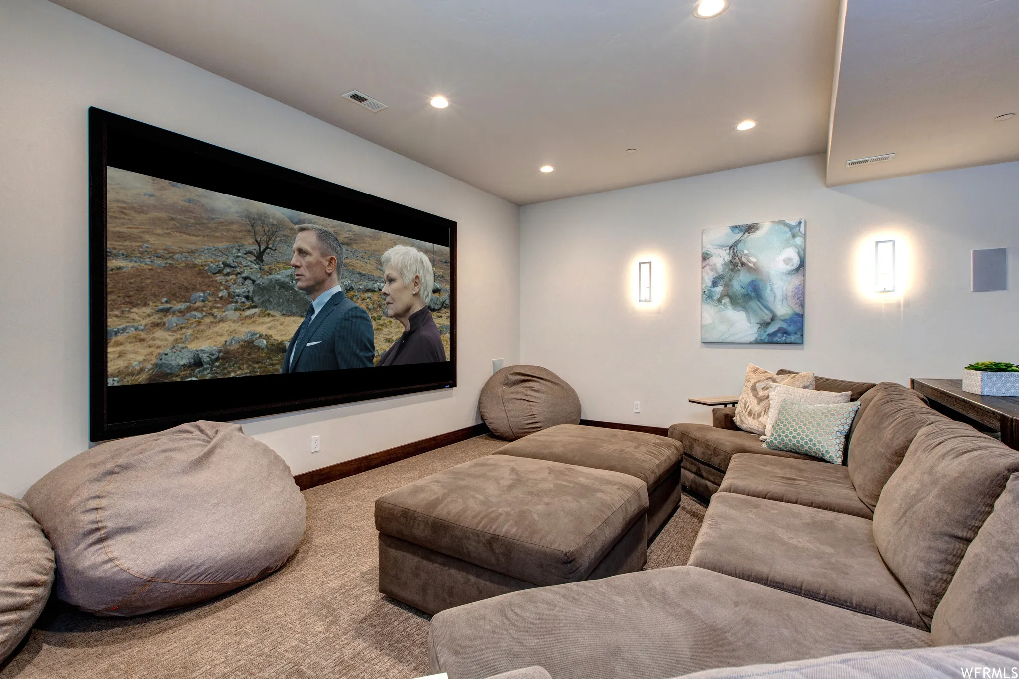 Carpeted home theater featuring recessed lighting and baseboards