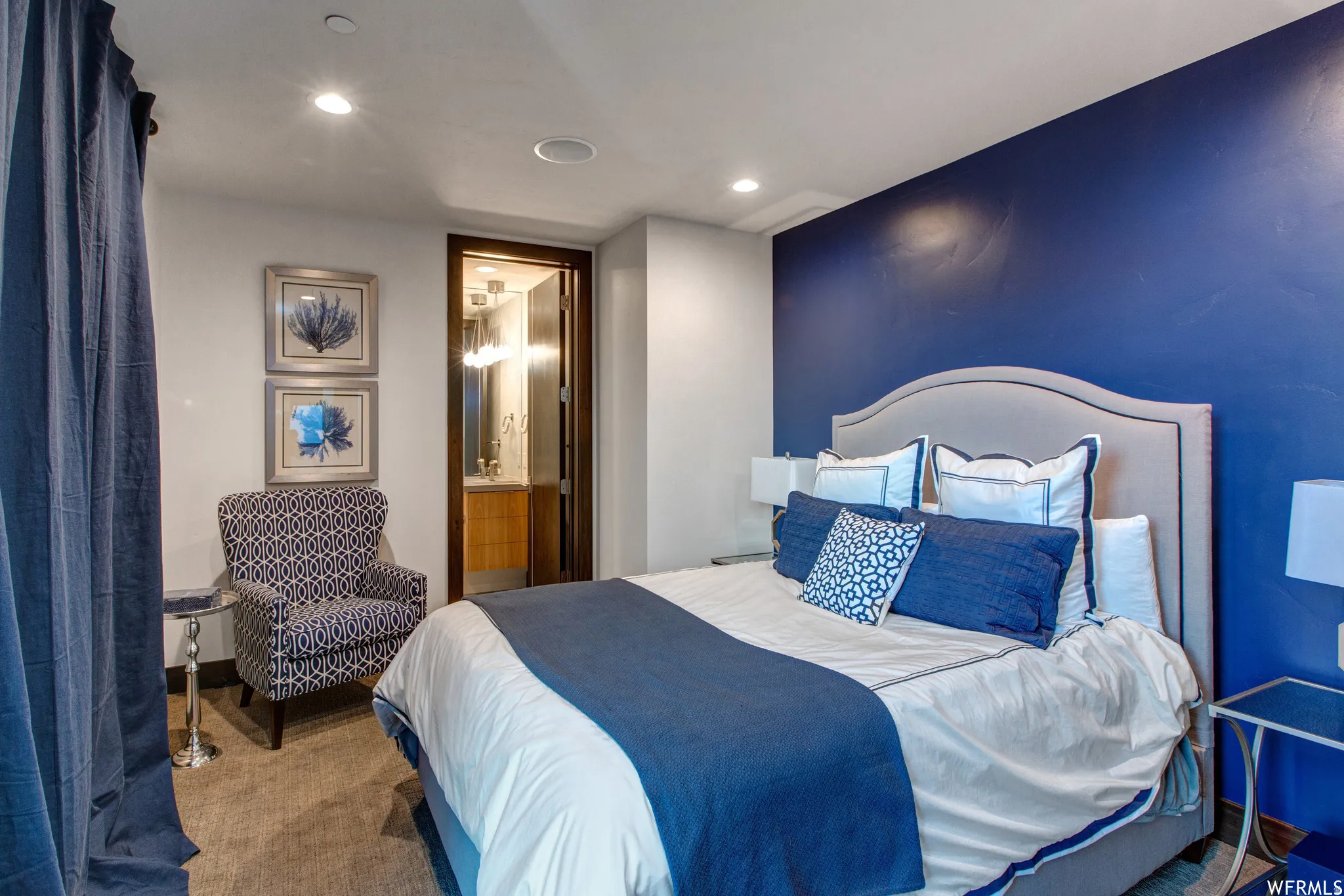 Carpeted bedroom featuring ensuite bath and recessed lighting