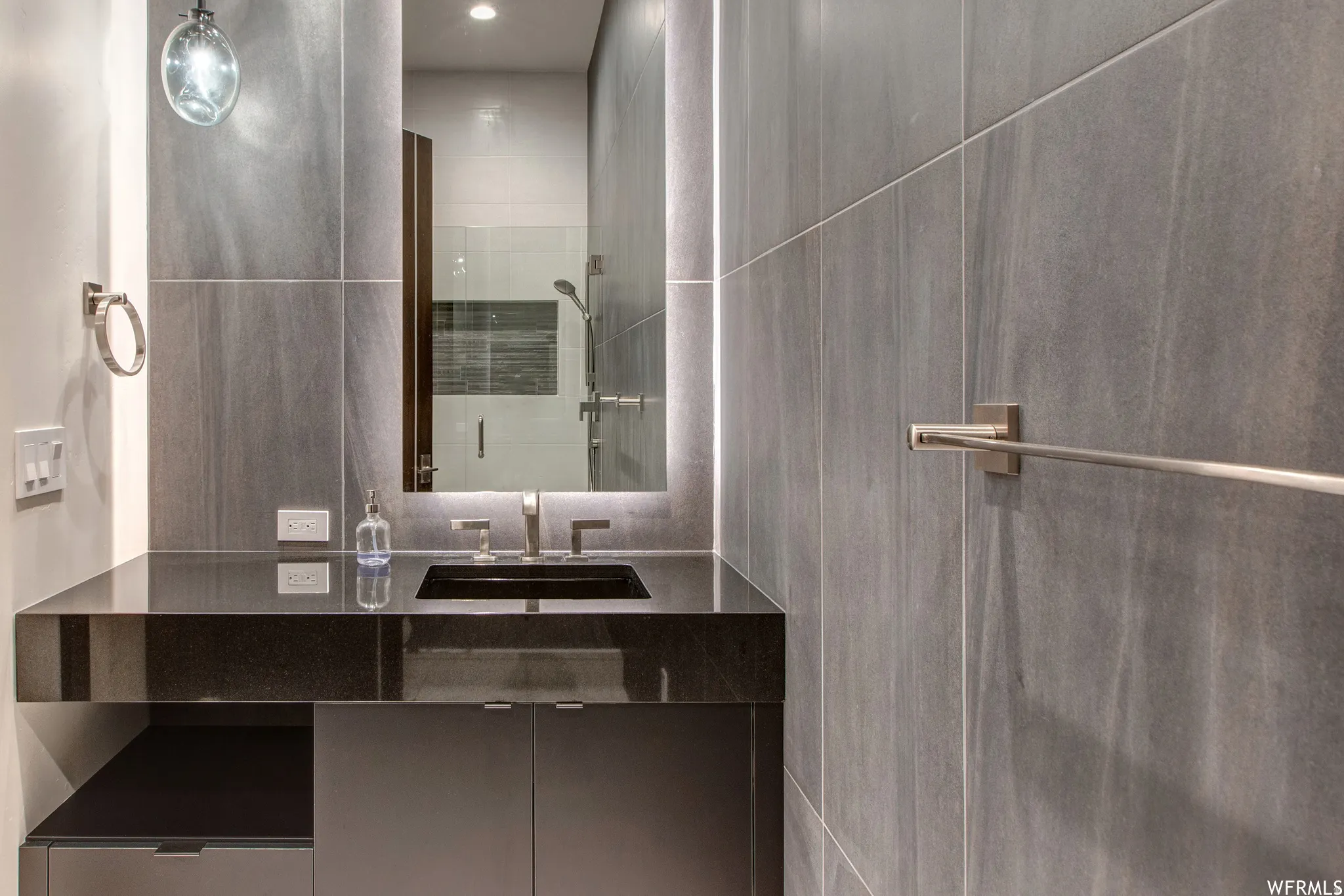 Bathroom with vanity and a shower stall