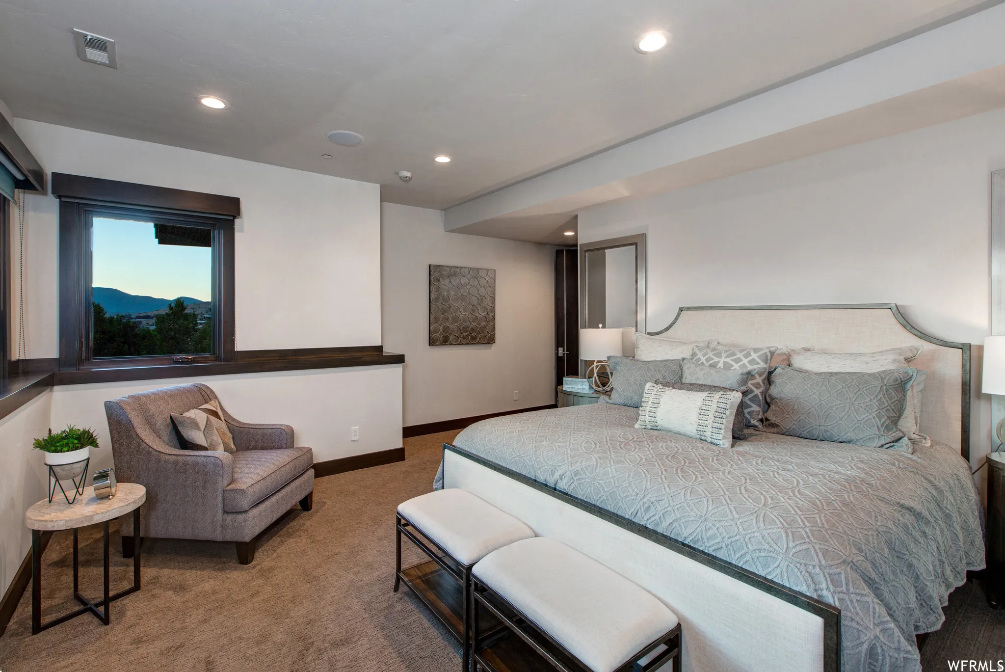 Carpeted bedroom with a mountain view and recessed lighting