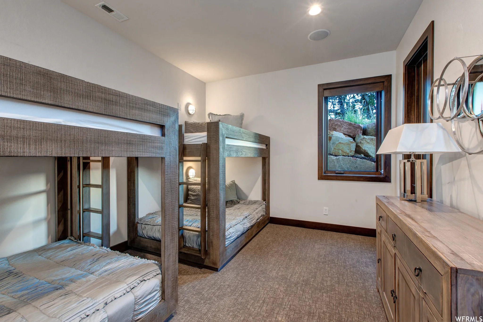 Bedroom with dark colored carpet and baseboards