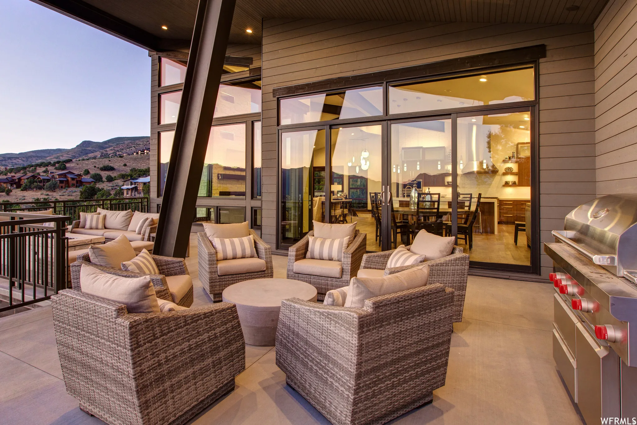 Patio terrace at dusk with an outdoor hangout area, area for grilling, a patio, and a mountain view