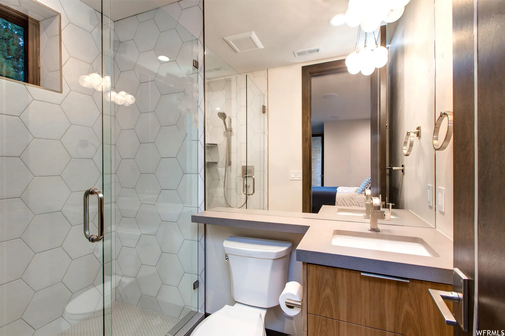 Ensuite bathroom with a shower stall and vanity