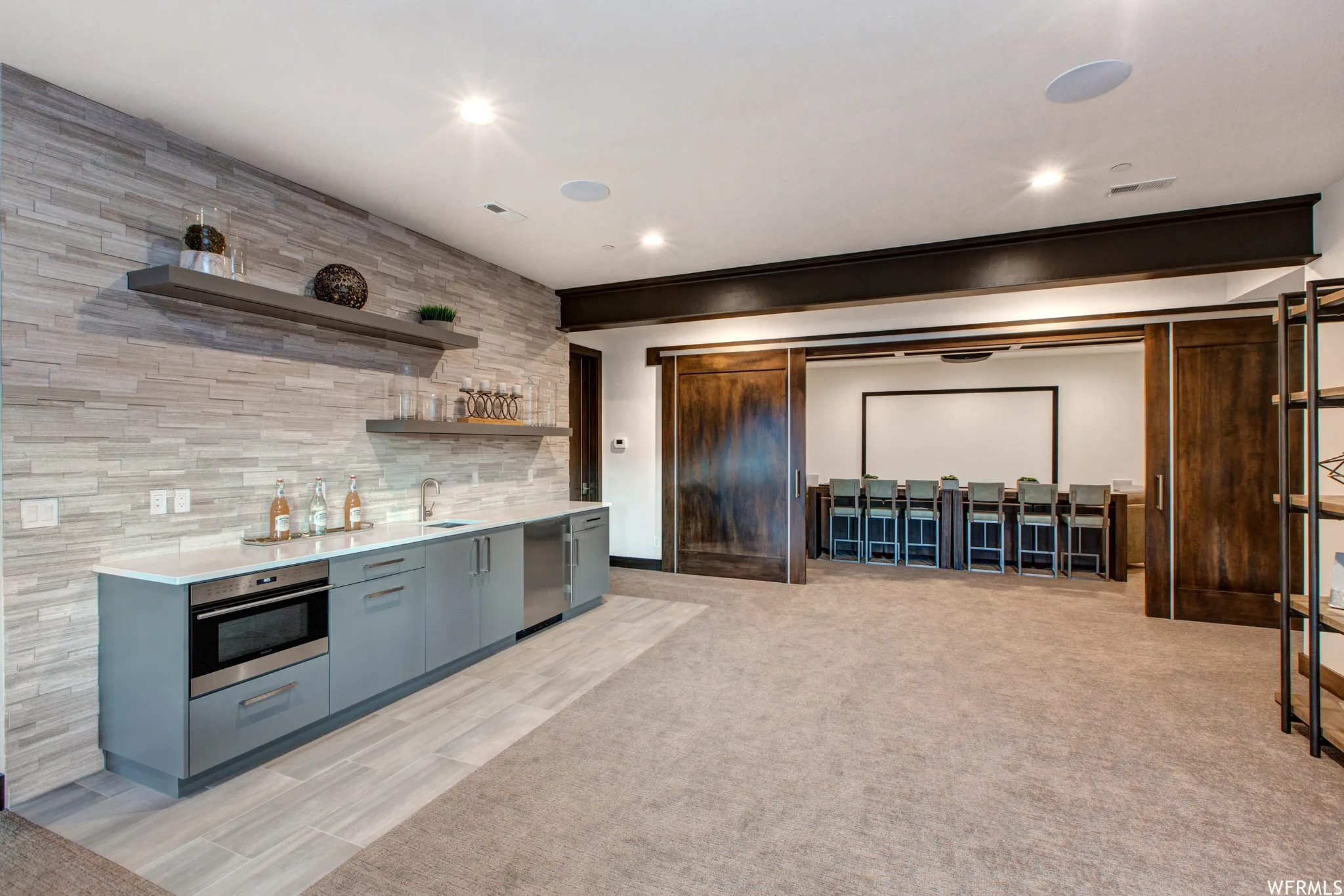 Kitchen featuring open shelves, stainless steel oven, gray cabinetry, recessed lighting, and wood tiled floors