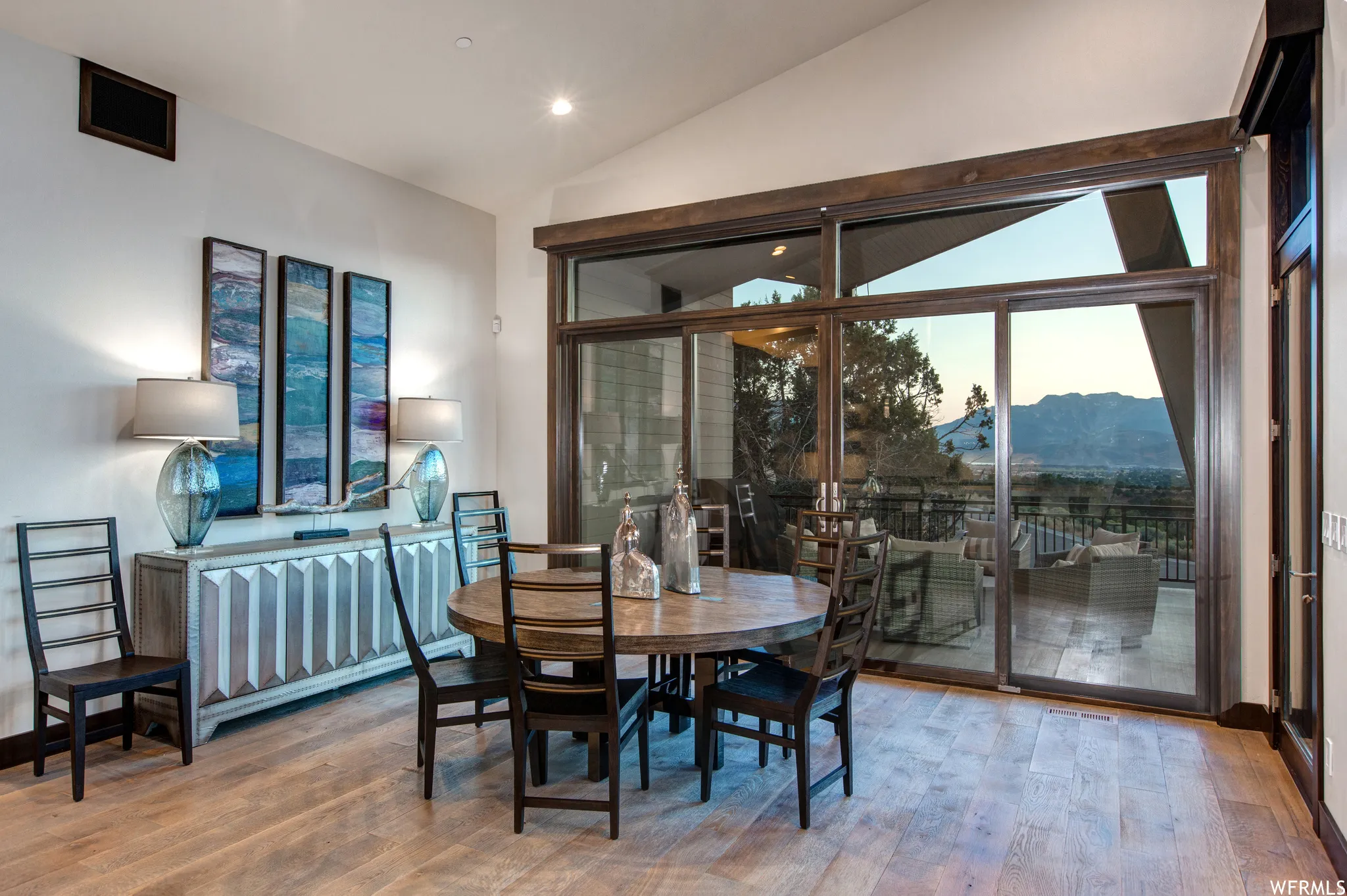 Dining area featuring a mountain view, lofted ceiling, wood finished floors, and recessed lighting