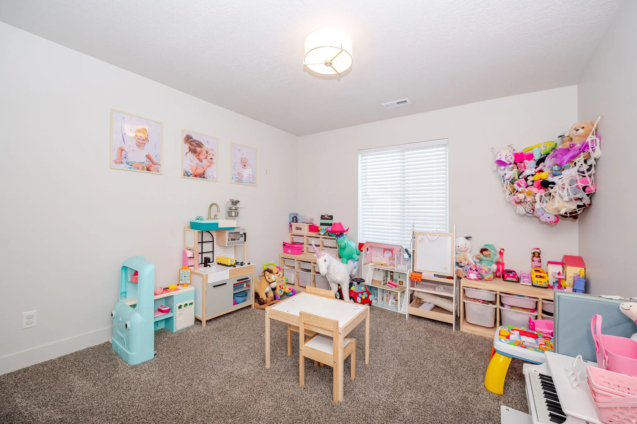 Playroom with carpet floors and baseboards