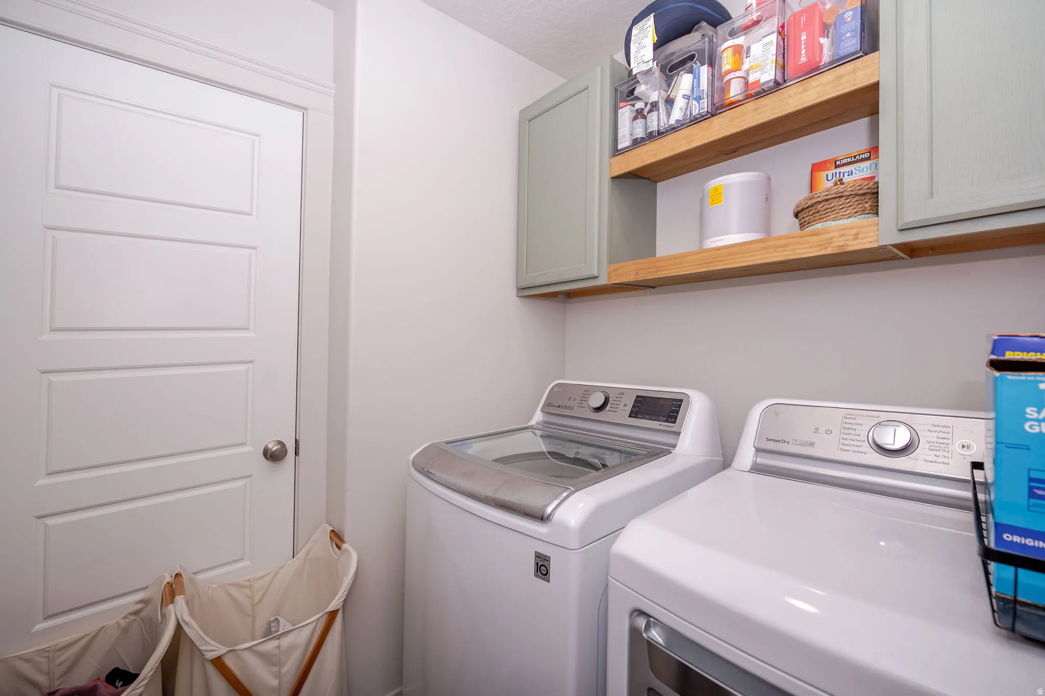 Laundry room with cabinet space and washing machine and dryer