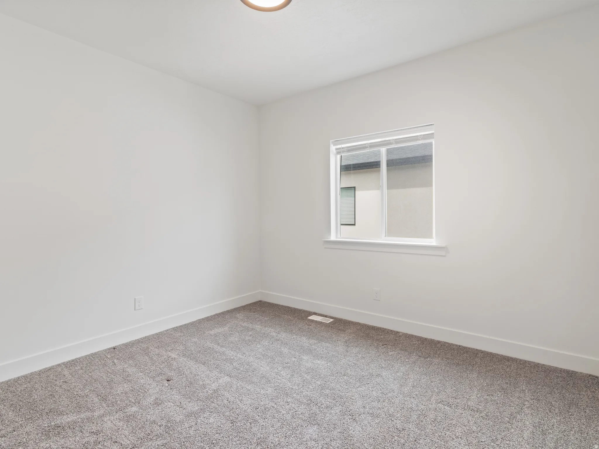 Unfurnished room featuring carpet and baseboards