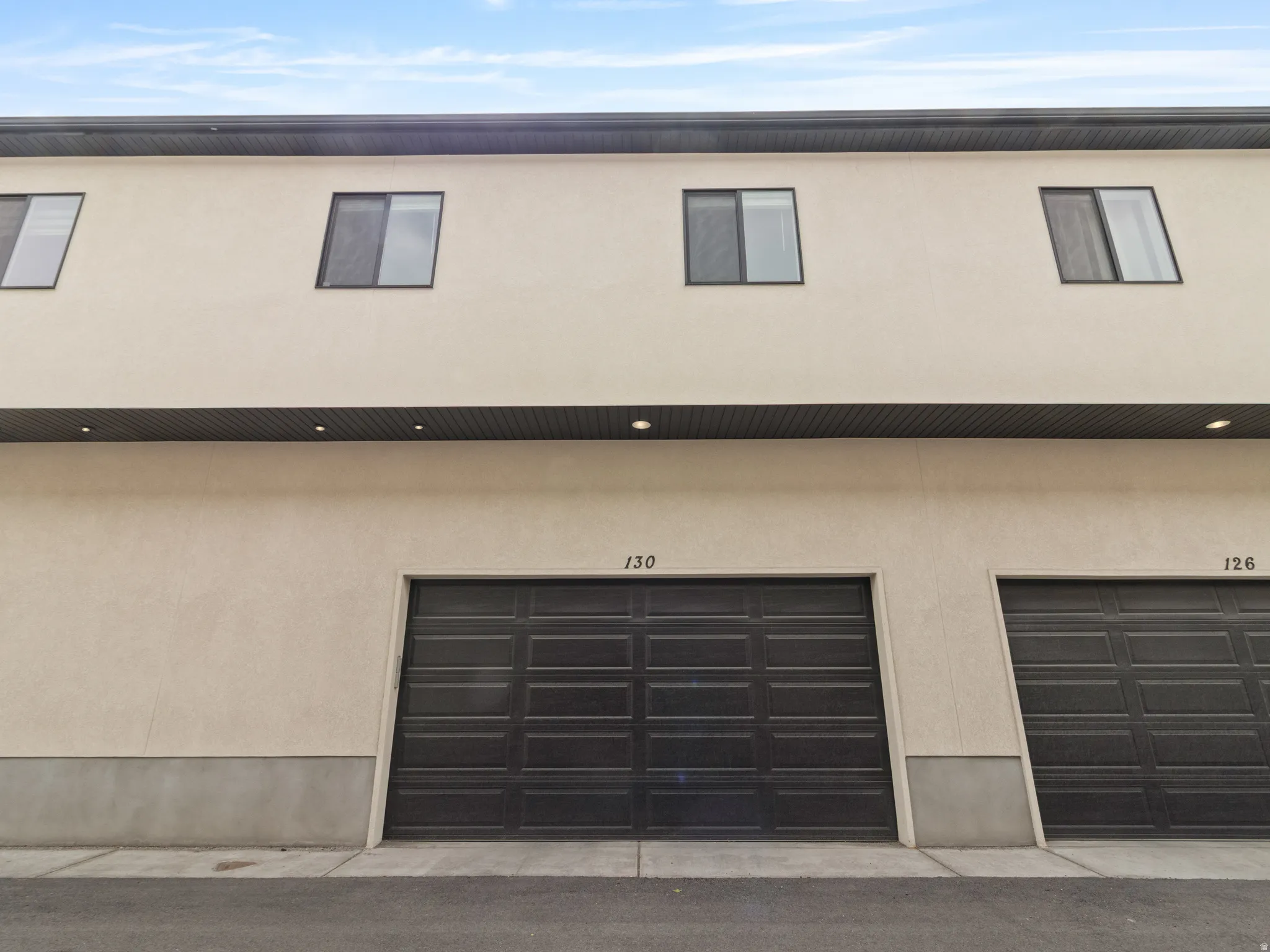 View of front facade featuring stucco siding and an attached garage