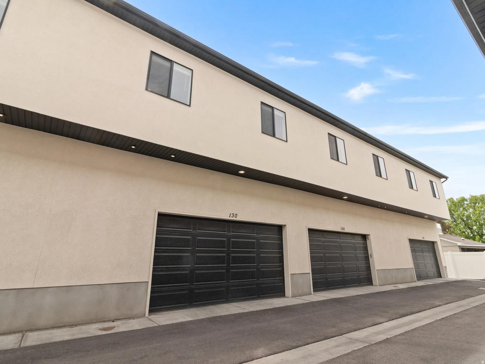 View of side of property featuring stucco siding and a garage