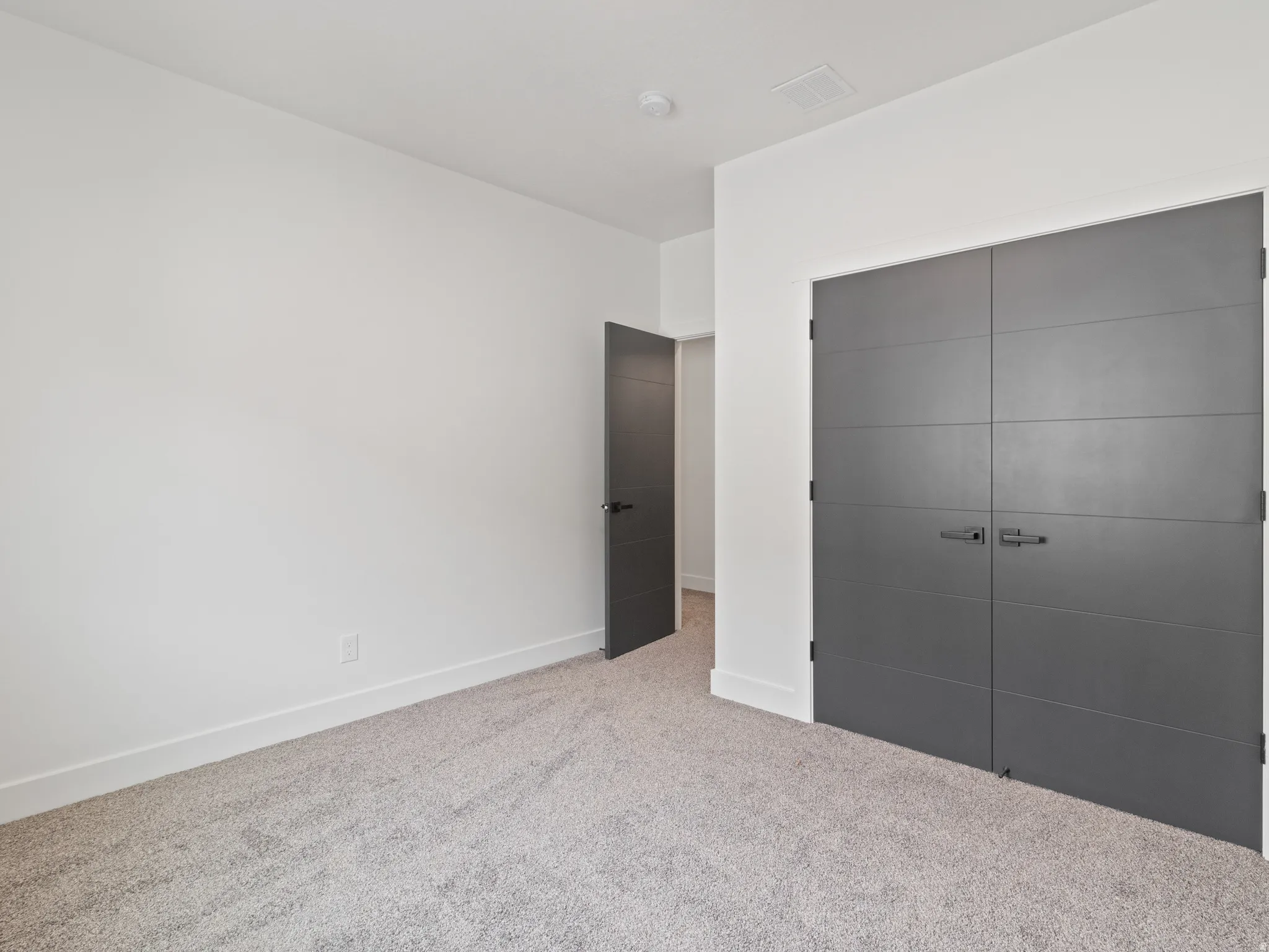 Unfurnished bedroom with a closet and carpet flooring
