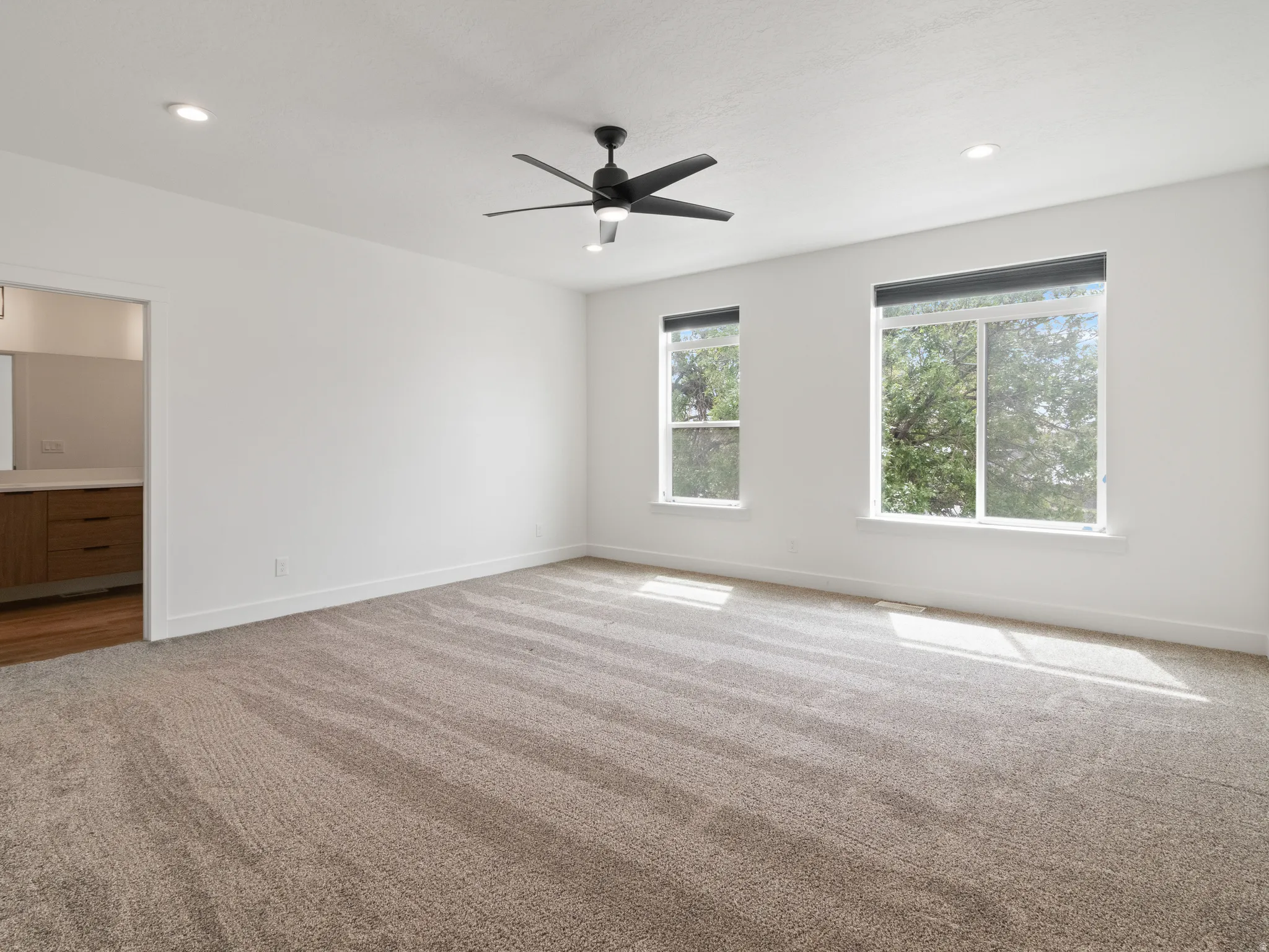 Unfurnished room featuring carpet floors, recessed lighting, and ceiling fan