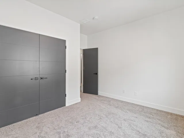 Unfurnished bedroom featuring a closet and carpet