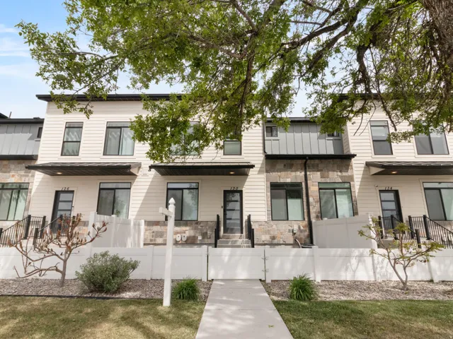 View of front of property featuring stone siding and a standing seam roof