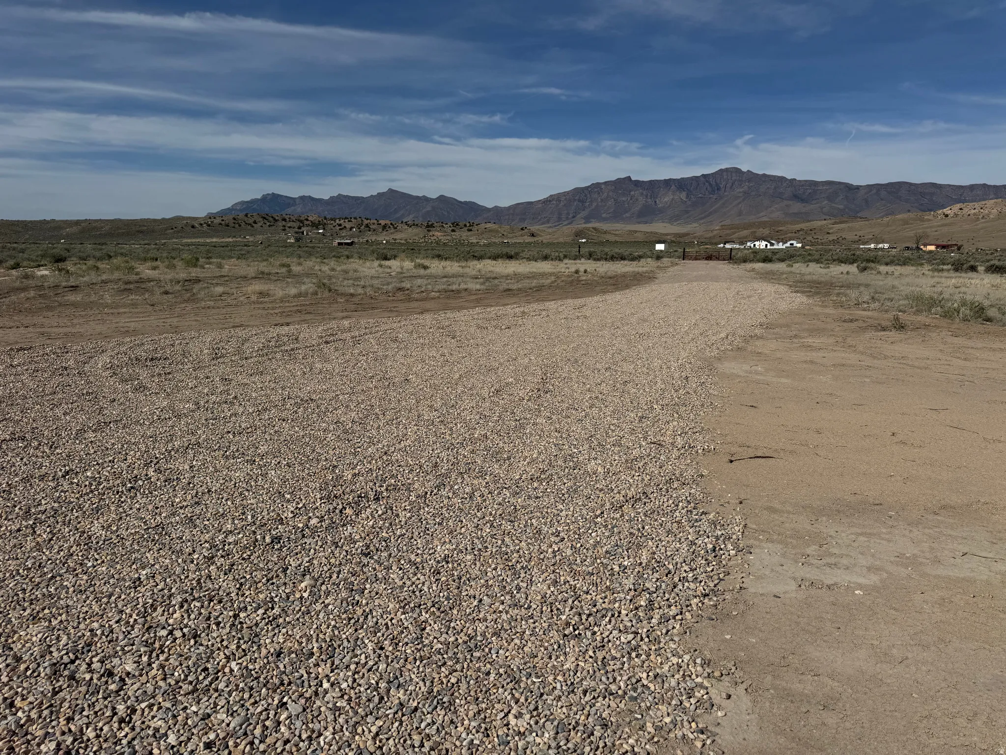 Gravel driveway. View of mountain backdrop