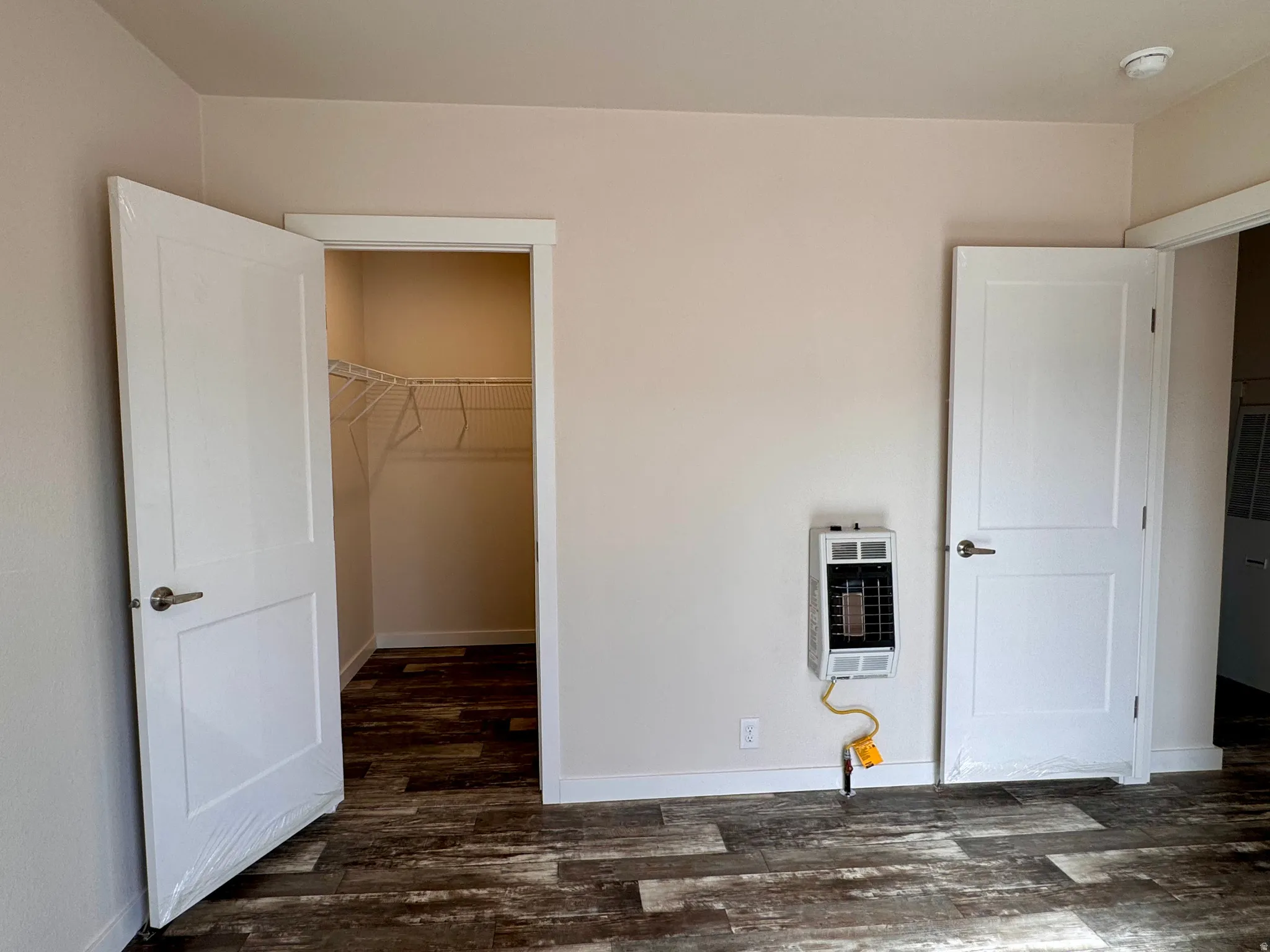 Bedroom #1 with independent wall heater.