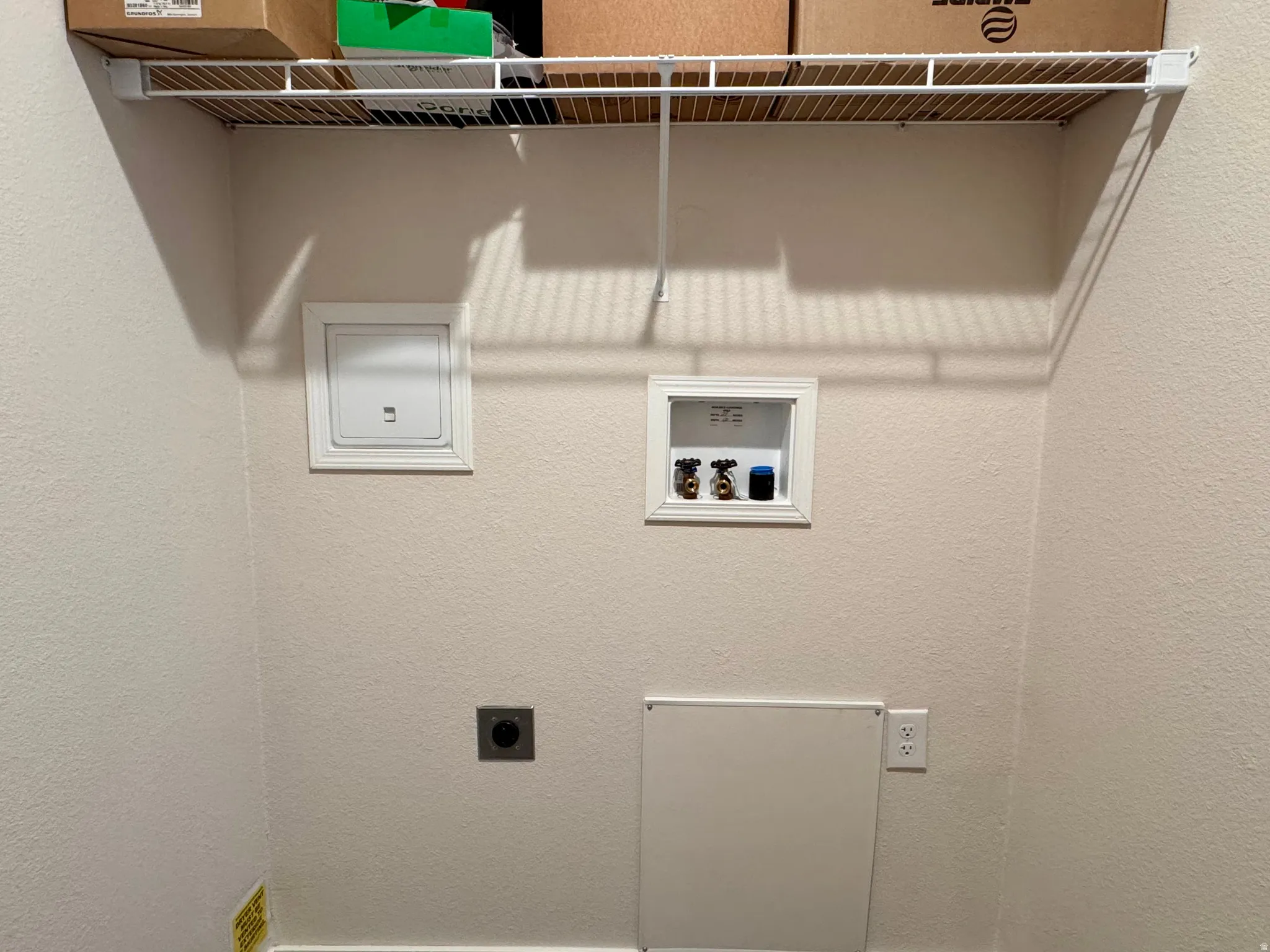 Laundry area with electric dryer hookup, hookup for a washing machine