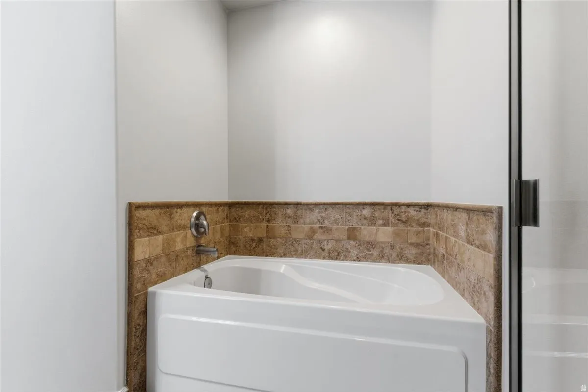 Primary Bathroom featuring a separate tub/shower