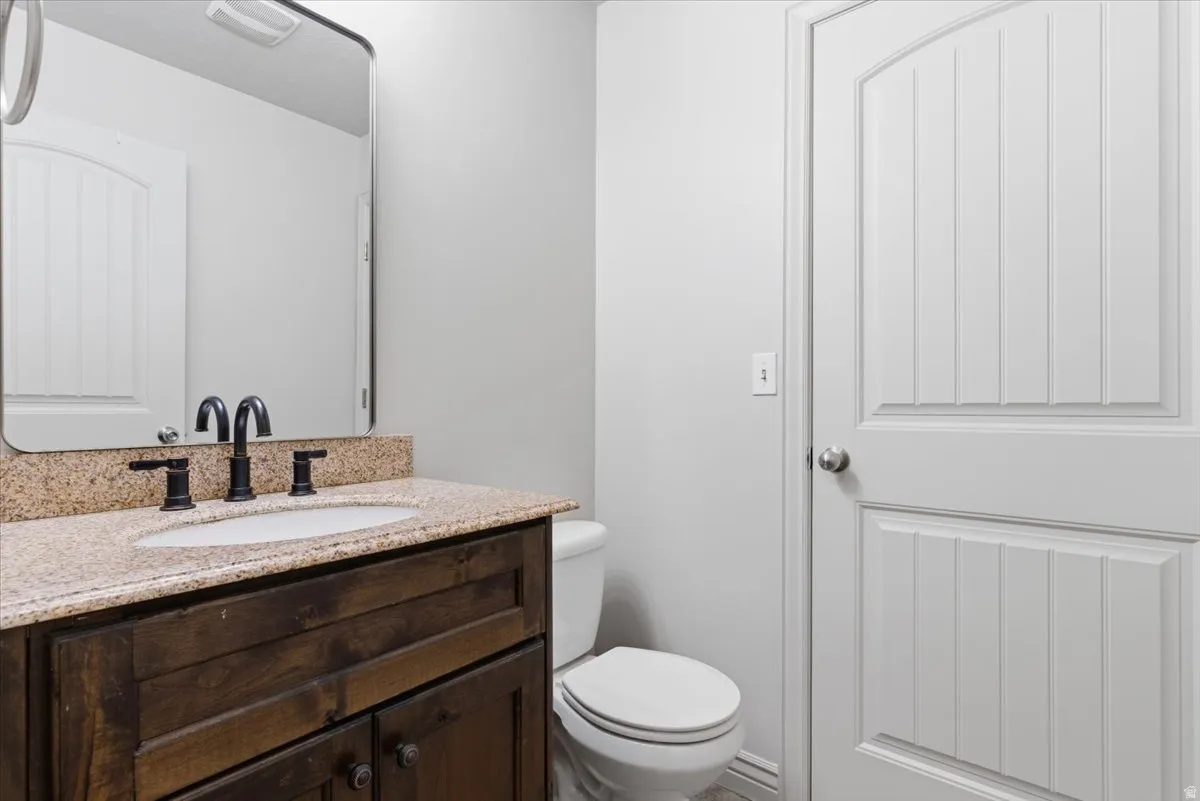 1/2 Bathroom with vanity and toilet