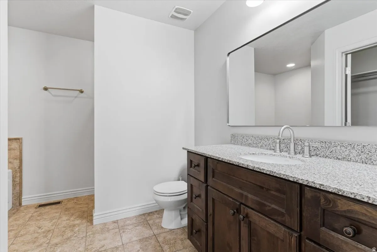 Primary Bathroom Full bath featuring vanity, light tile patterned floors, and recessed lighting