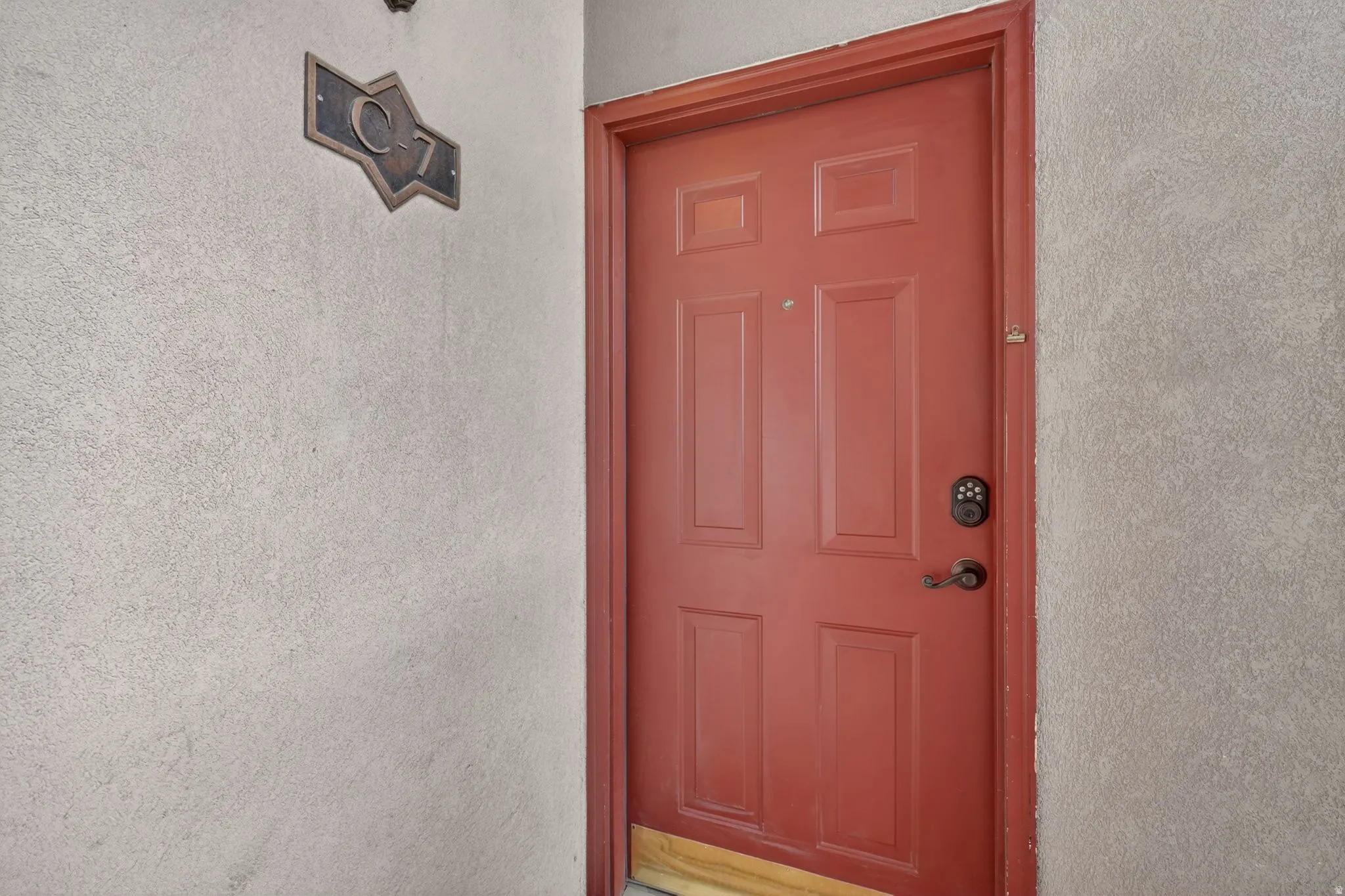 Property entrance featuring stucco siding