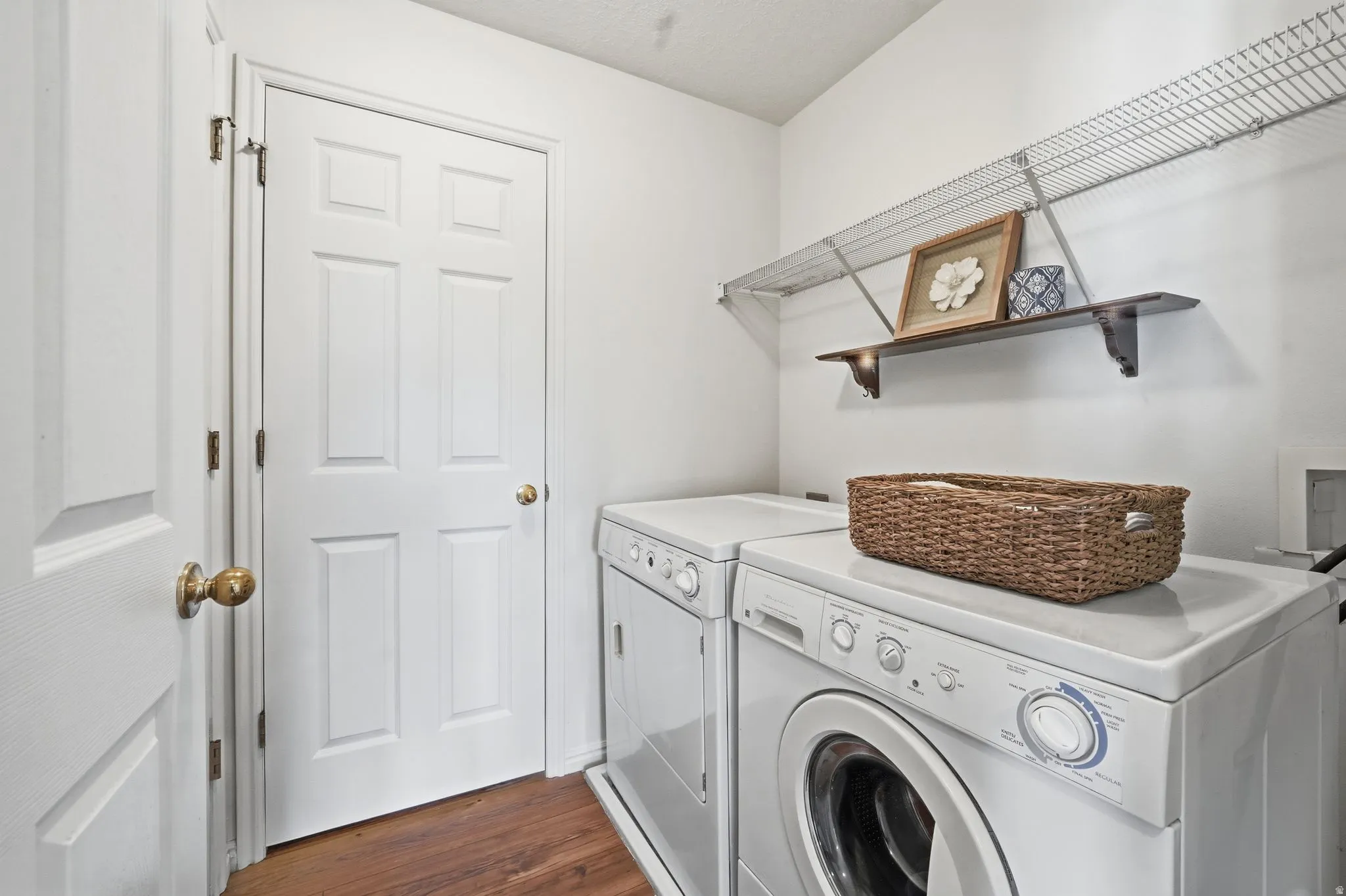 Laundry room with dark wood-type flooring and separate washer and dryer
