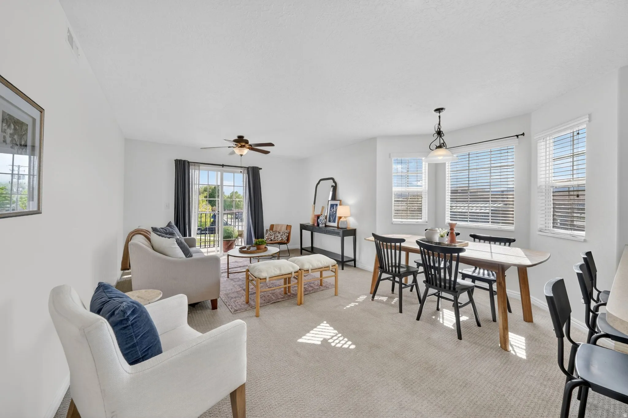 Dining room featuring light carpet and ceiling fan