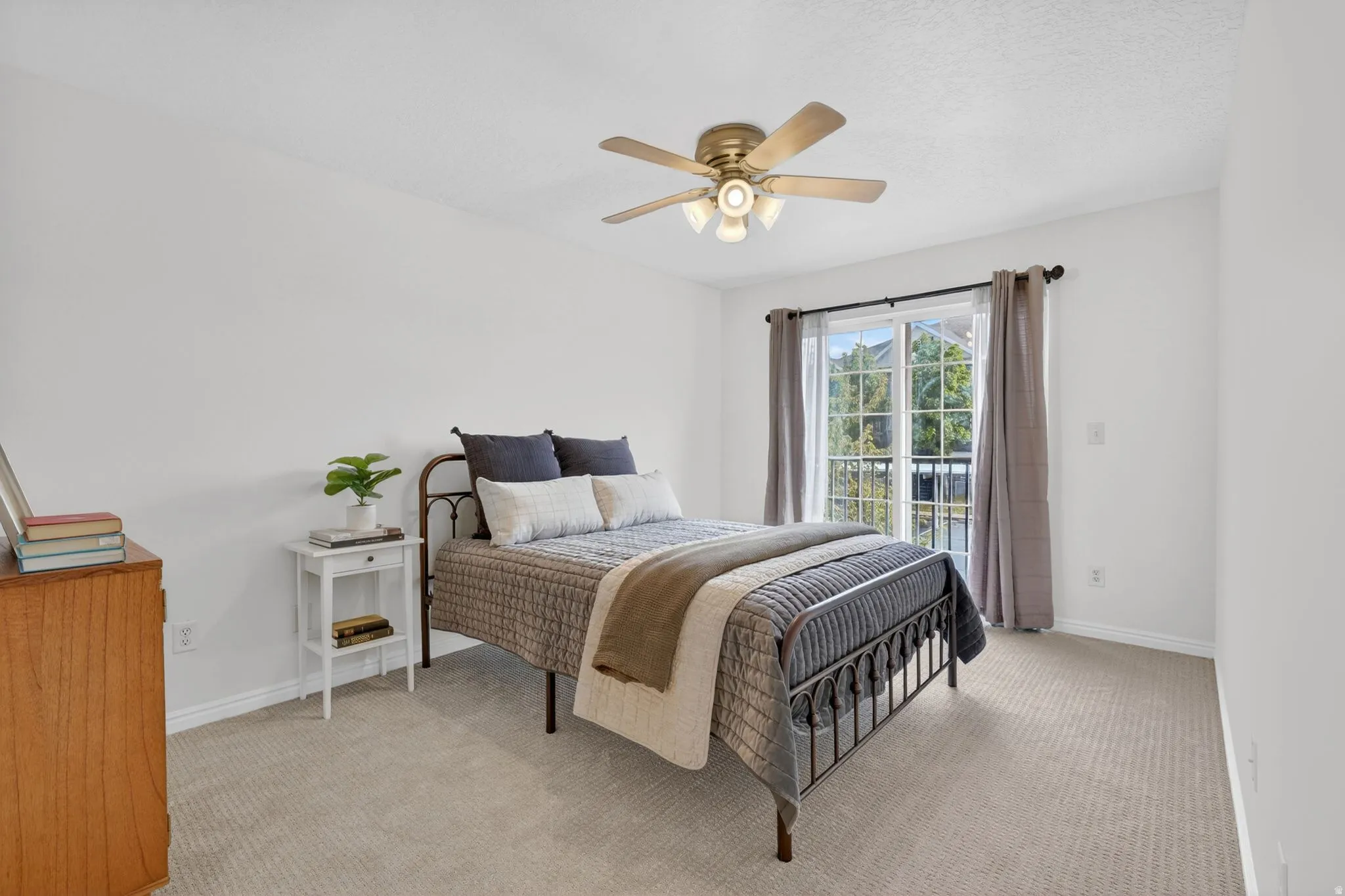 Bedroom featuring light colored carpet, access to outside, and a ceiling fan