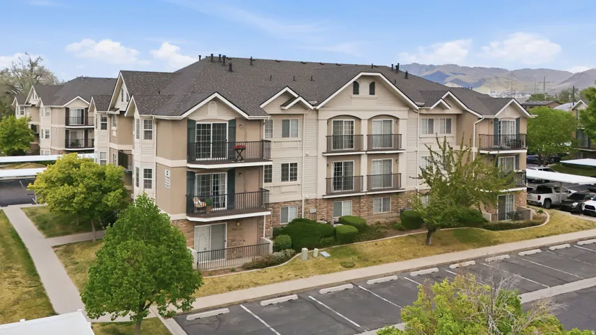 View of property with uncovered parking, a mountain view, and a residential view
