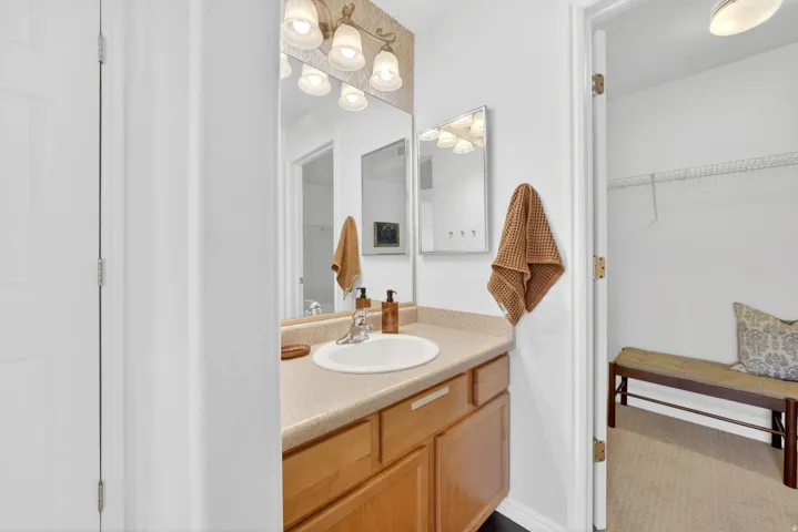 Bathroom featuring vanity and a spacious closet