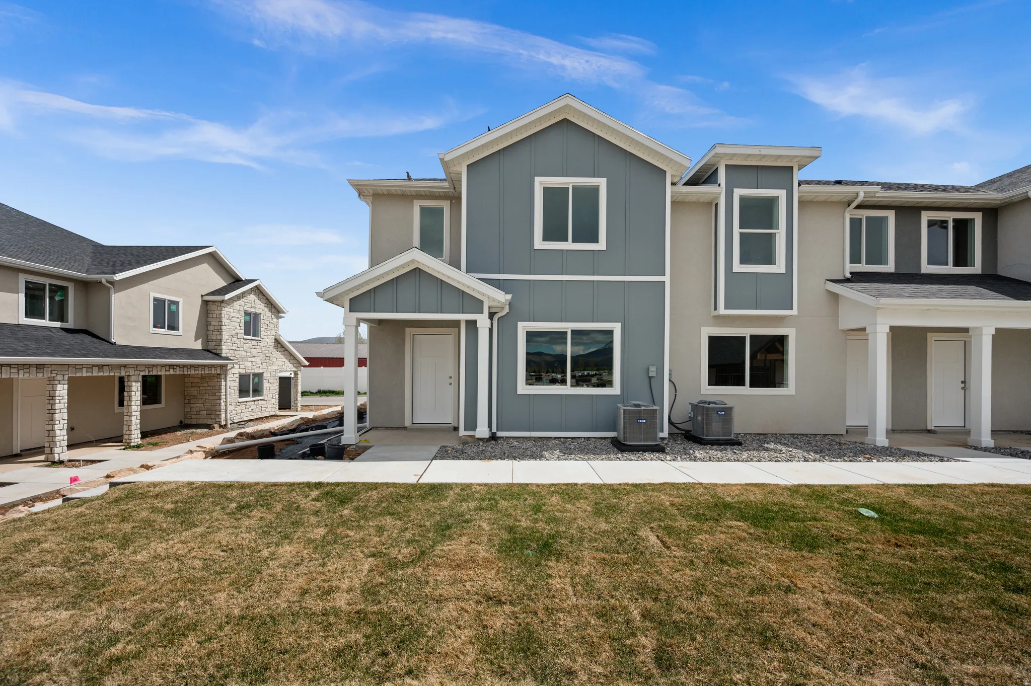 View of front of house featuring board and batten siding and a front lawn