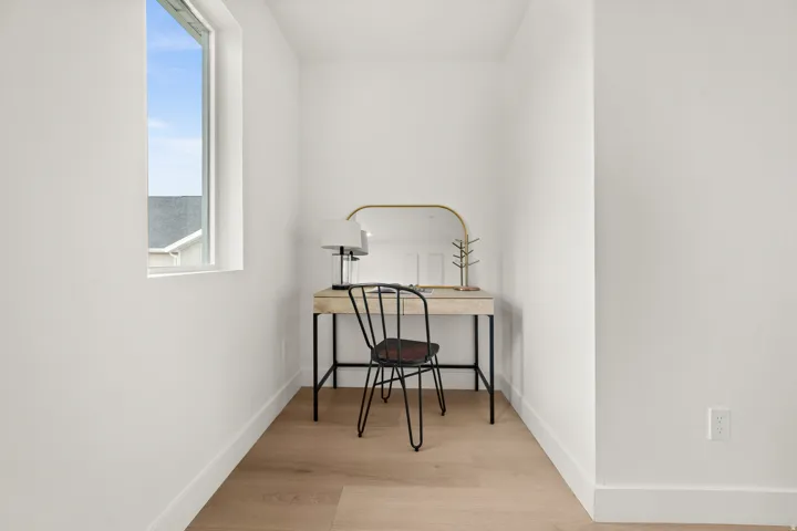 Office area featuring light wood-style flooring and baseboards