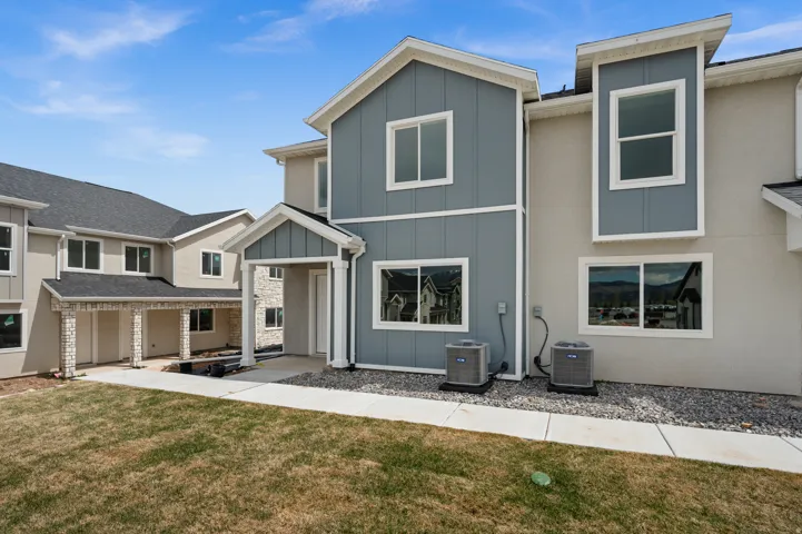 View of front of house with board and batten siding and a front yard