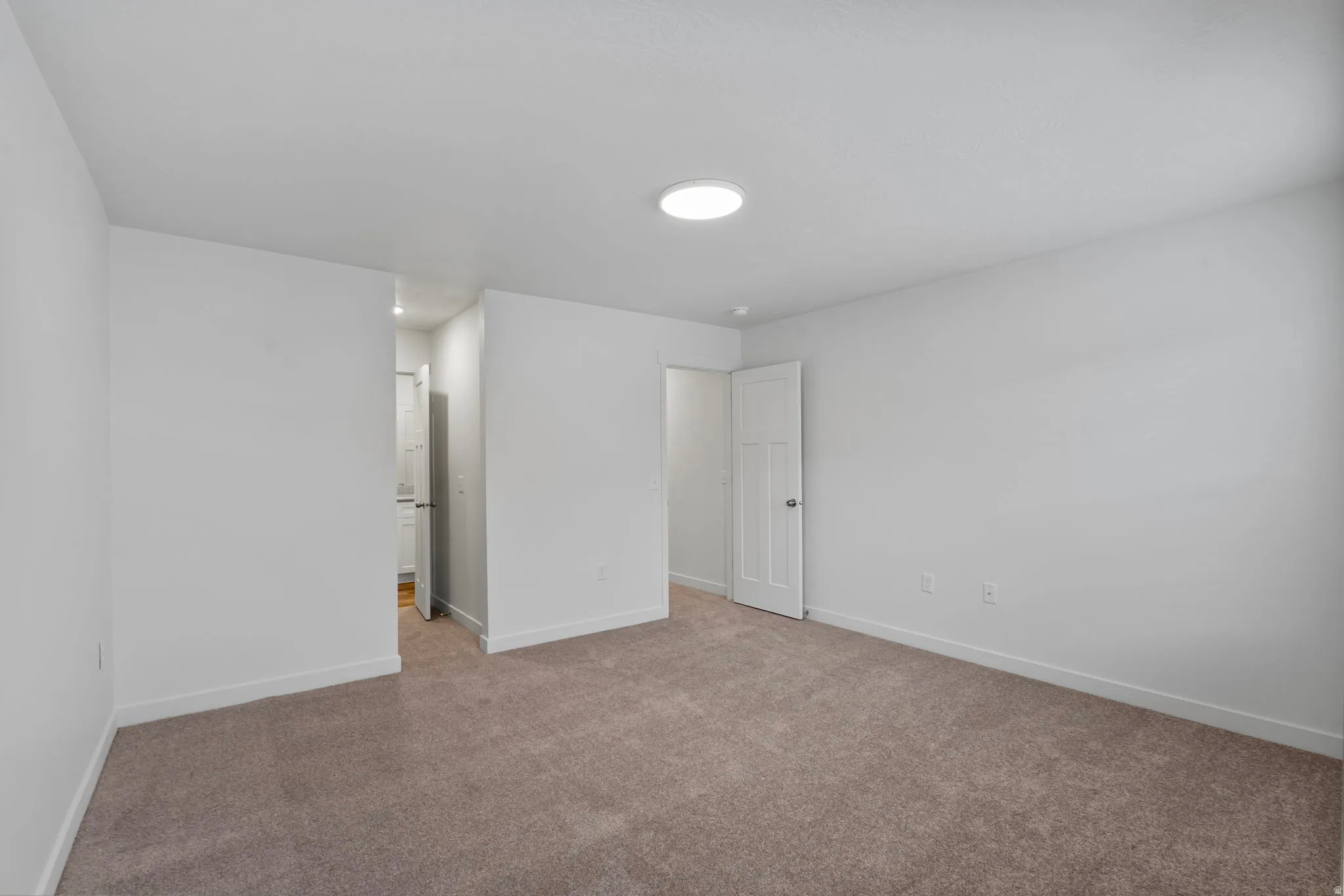 Unfurnished bedroom with baseboards and carpet