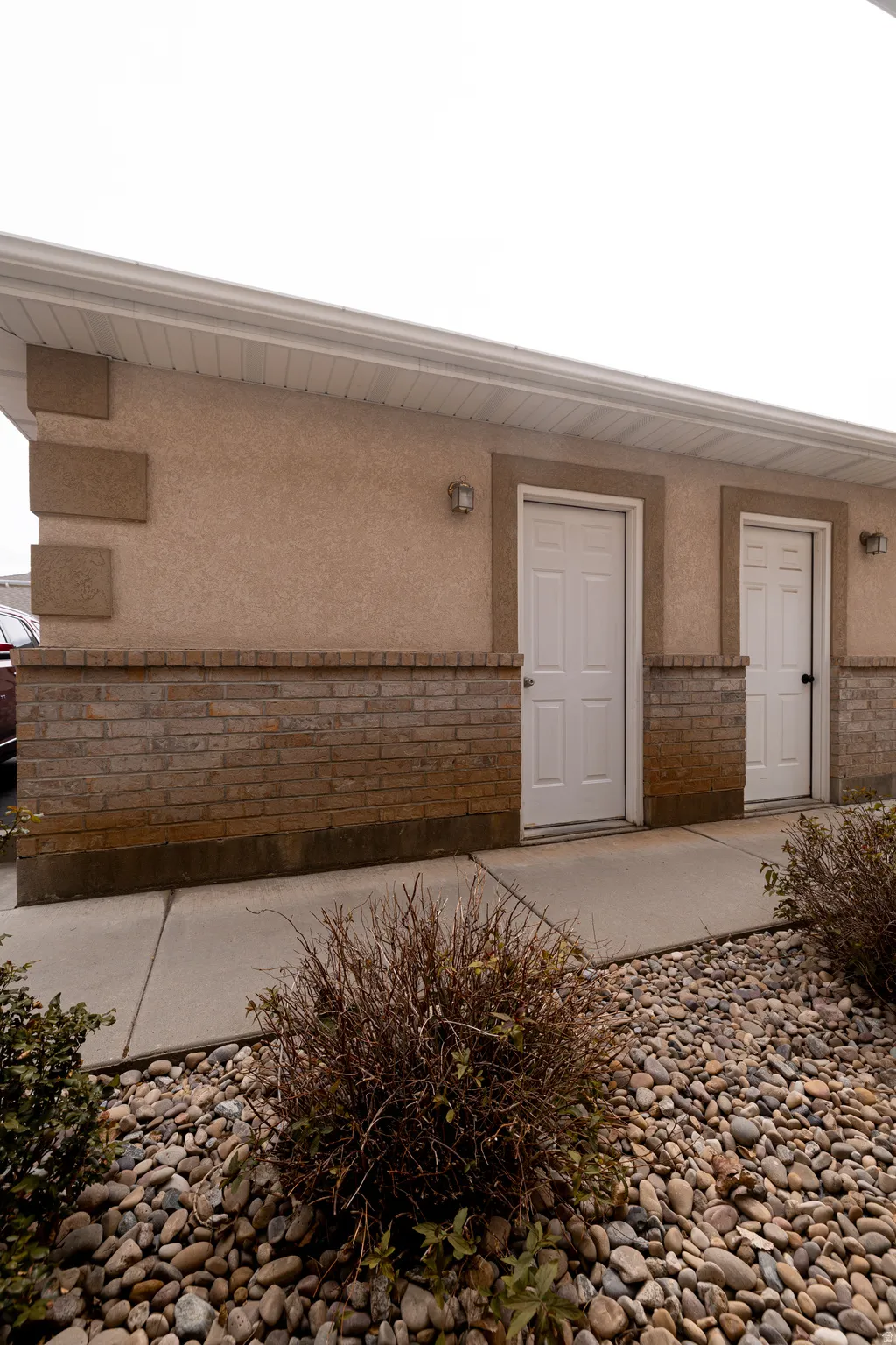 Garage entrance with stucco siding