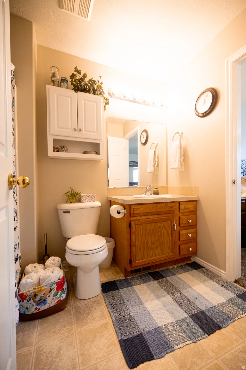 Full bath with vanity and light tile patterned floors