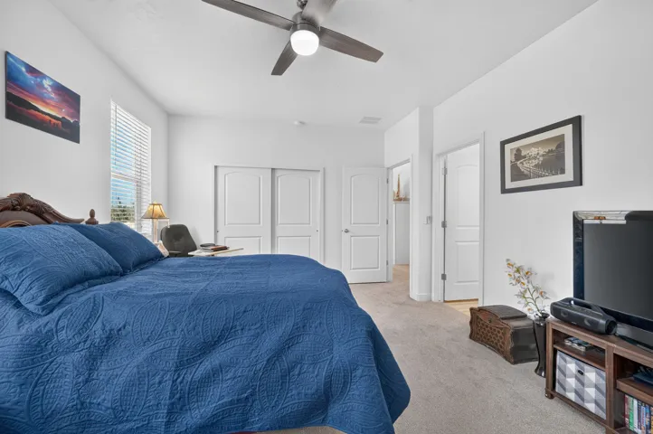 Spacious interior with neutral-toned carpeting and vaulted ceilings