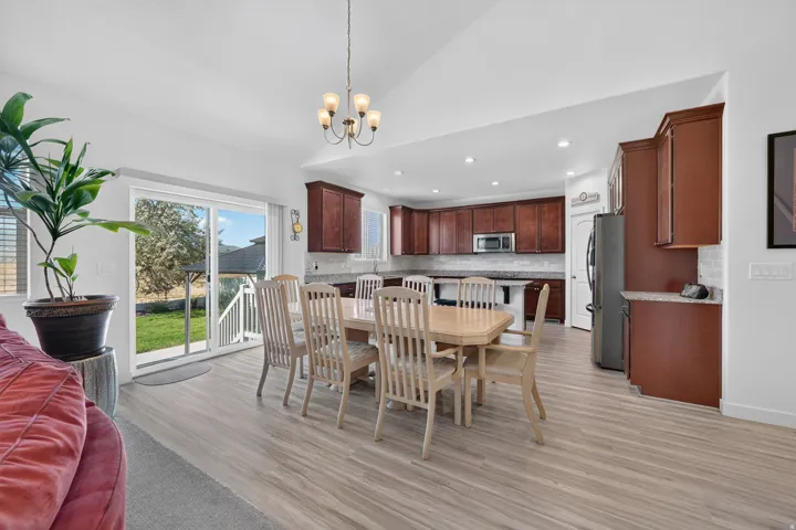 Open concept living space featuring wood-finish flooring, recessed lighting, and a chandelier